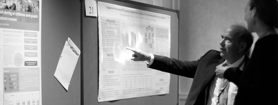 A man pointing at a poster at the Montreal ISCI confrence 