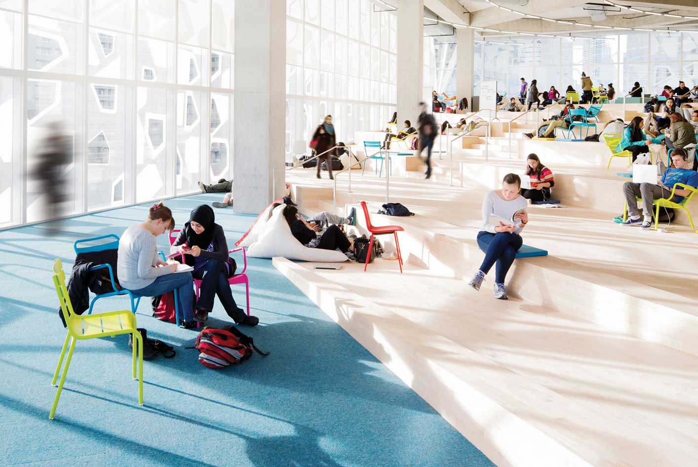 Students scattered around on the beach floor of the Student Learning Centre, bright and airy