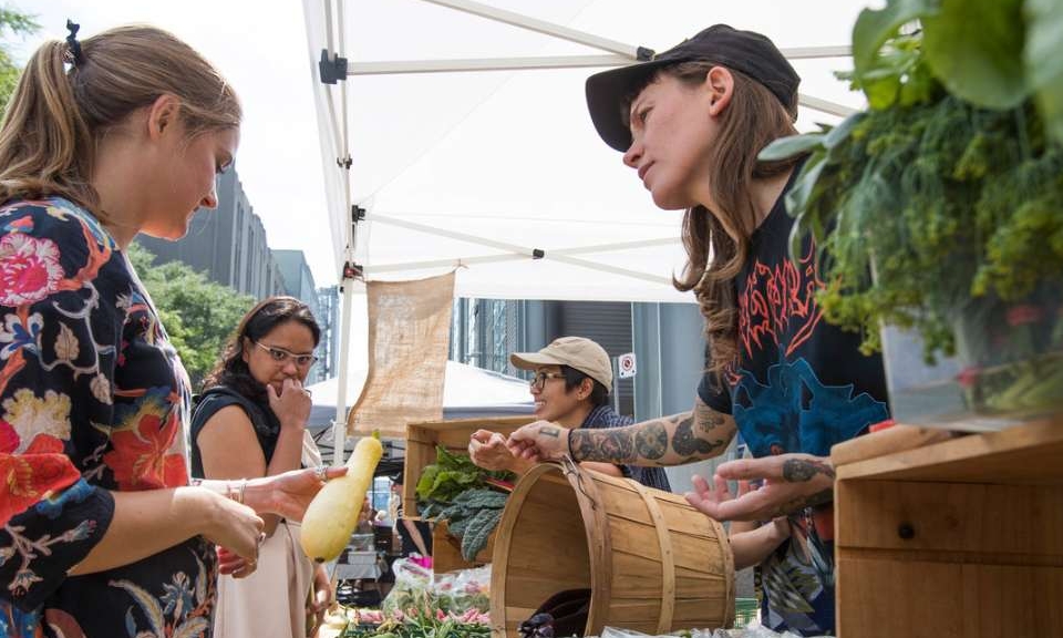Students and public walking about Gould Street to partake in the Farmers Market during the summer.