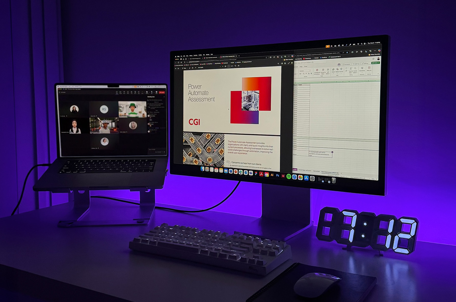 Laptop and monitor on a desk during a meeting