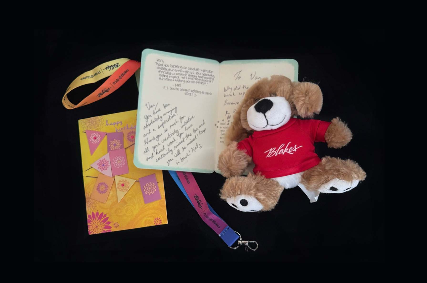 Farewell handwritten notes from co-workers and manager, placed next to a small teddy bear gift