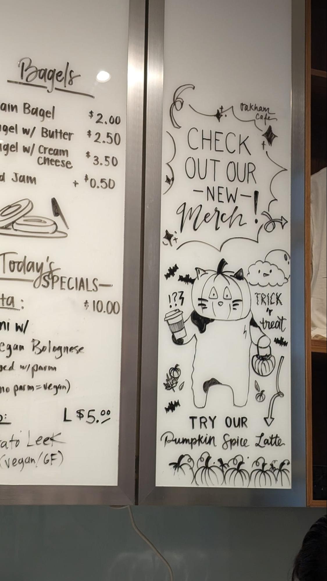 Whiteboard menu with a pumpkin illustration promoting the Pumpkin Spice Latte
