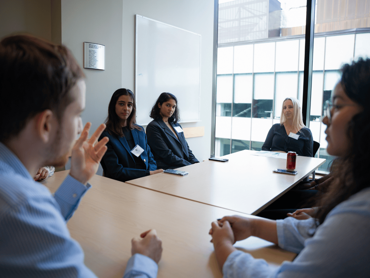 TMU students pictured in the Ted Rogers School of Management building in formal clothes