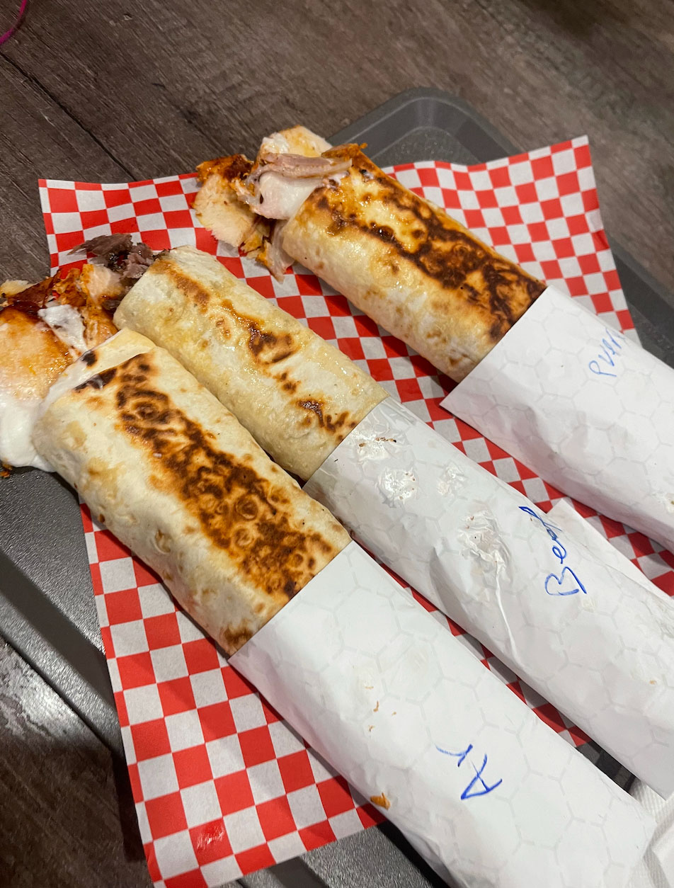 Shawarma wraps on checkered paper.
