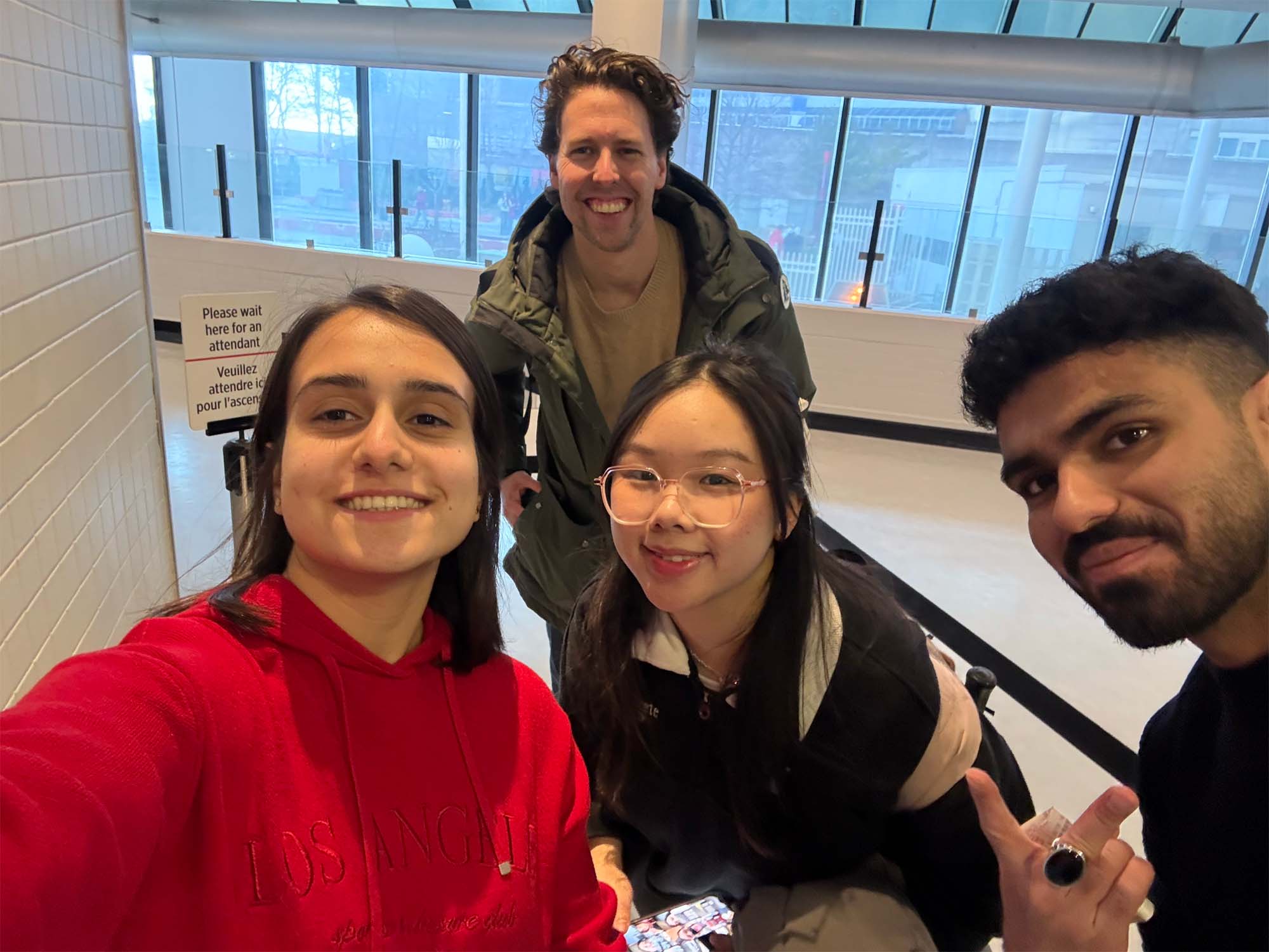 Julie and her friends smiling for a selfie indoors