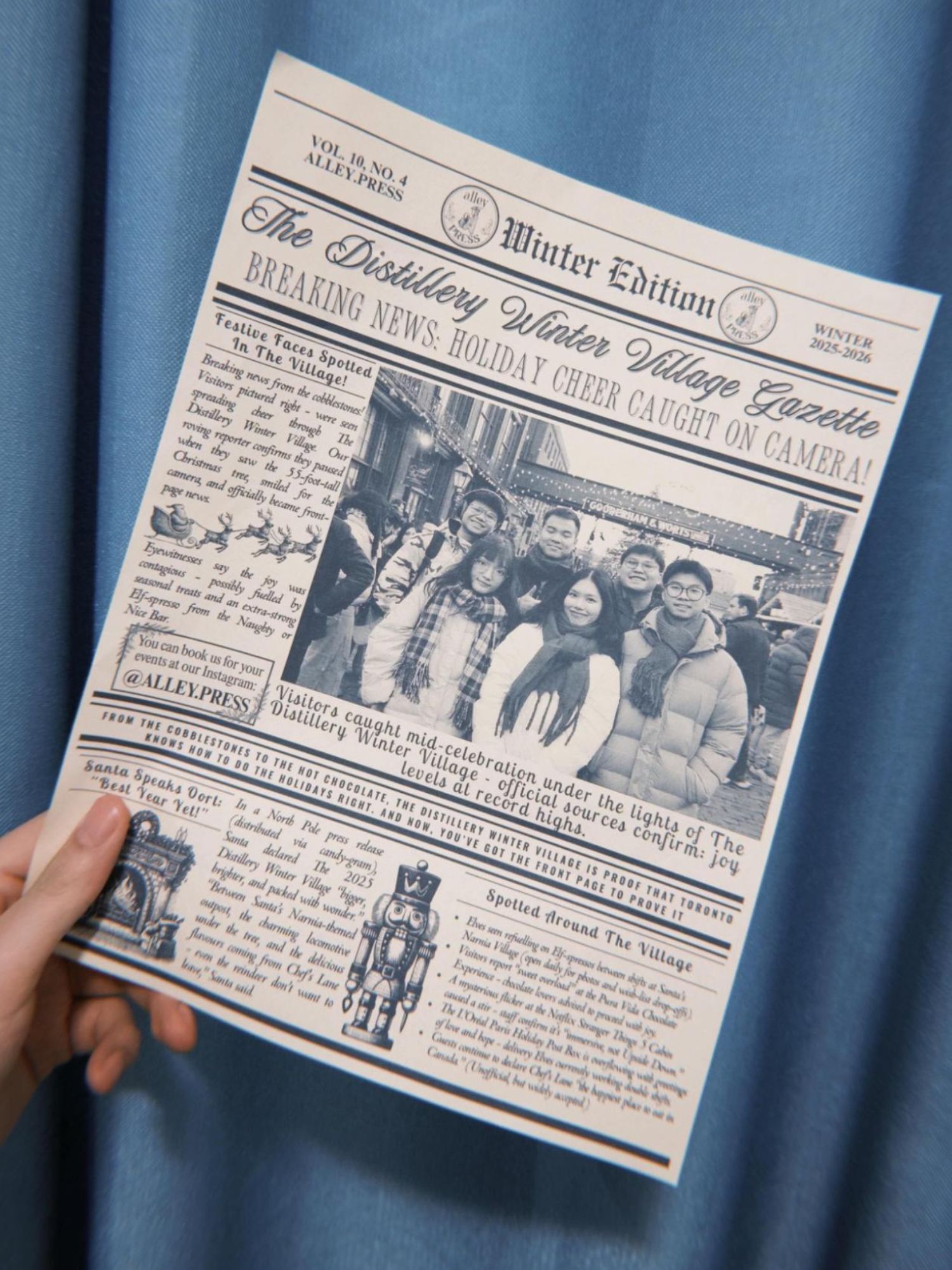 Photo on a newspaper of students posing at a outdoor christmas market 