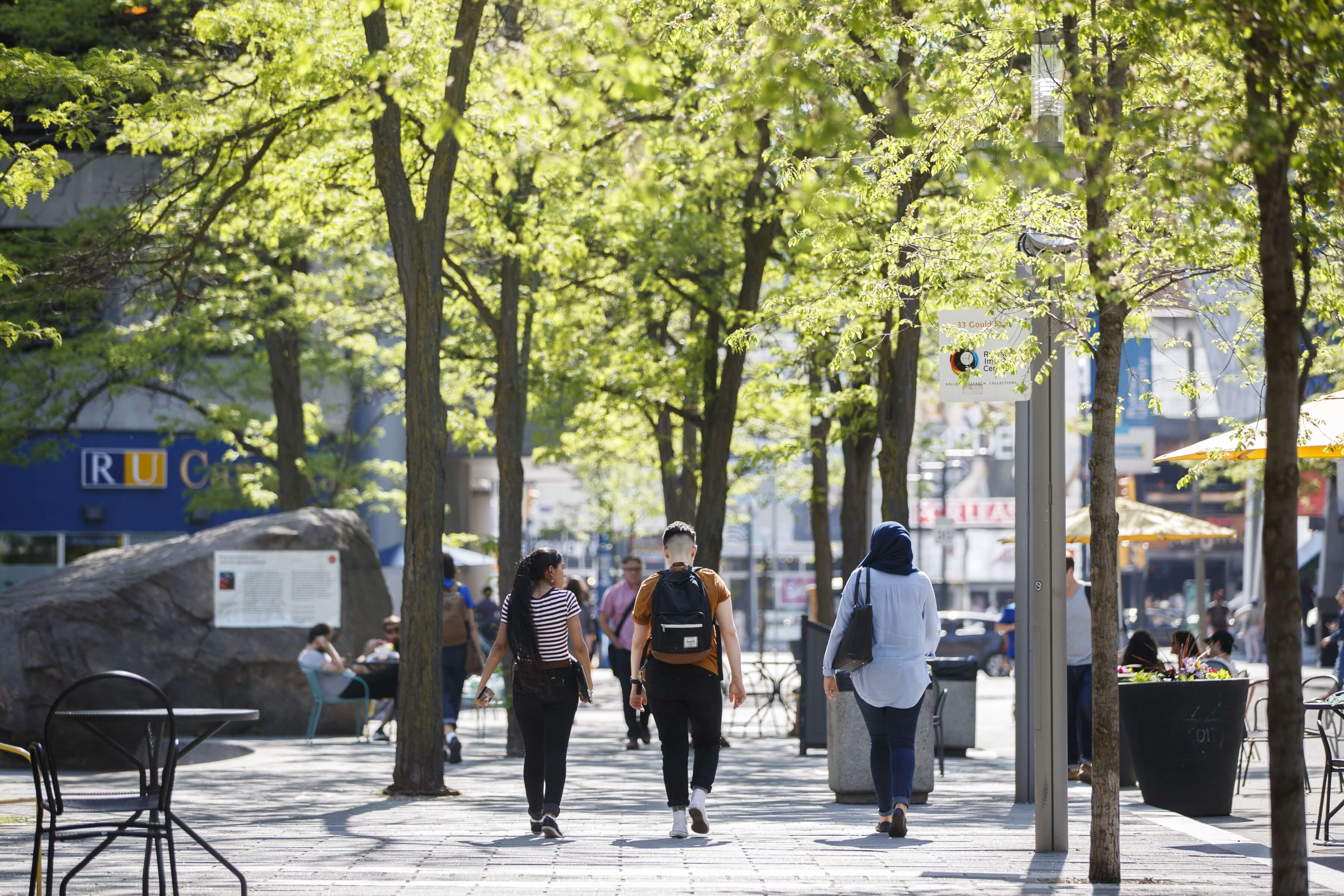 Three students walking on campus