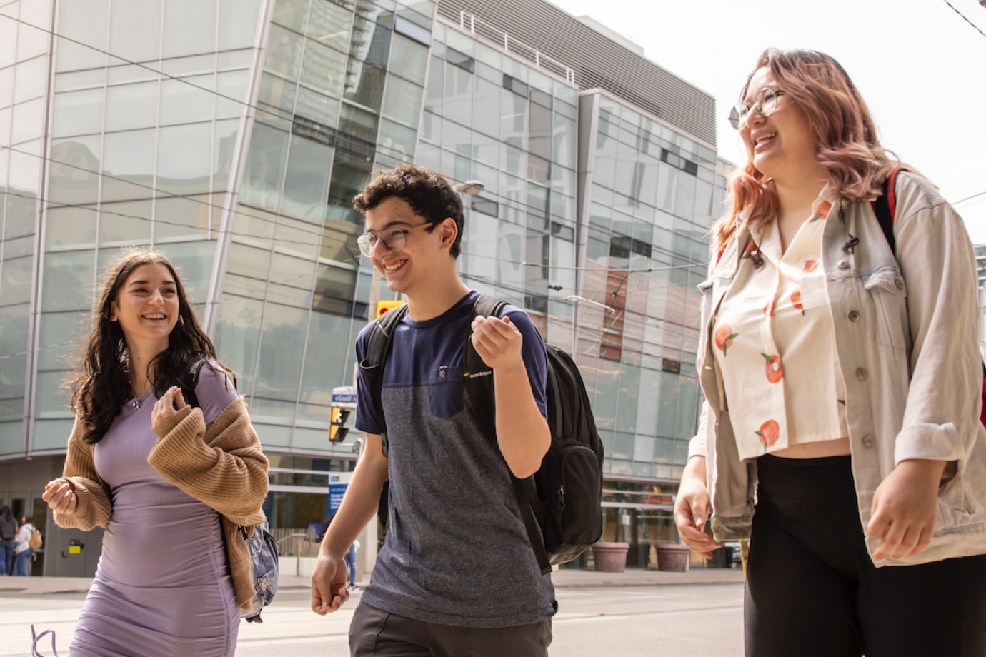 Three students walking on Church St with the George Vari Engineering and Computing Centre in the background