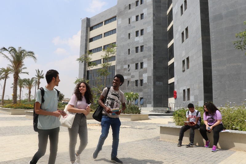 Students walking and sitting outside at the Cairo campus