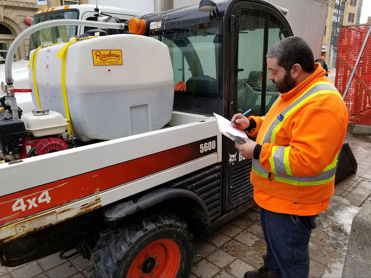A facilities employee goes over an inspection checklist for a TMU vehicle.