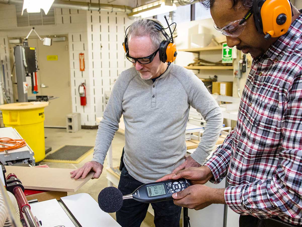A workshop inspection includes a decibel meter measuring the level of noise.