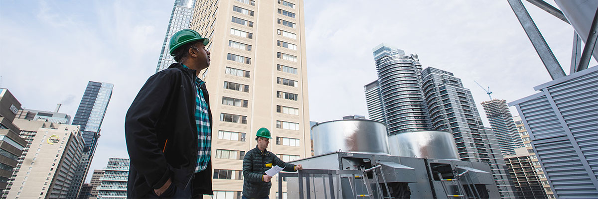 Health and safety inspectors examine a rooftop to check fall arrest safety systems and identify any other hazards.