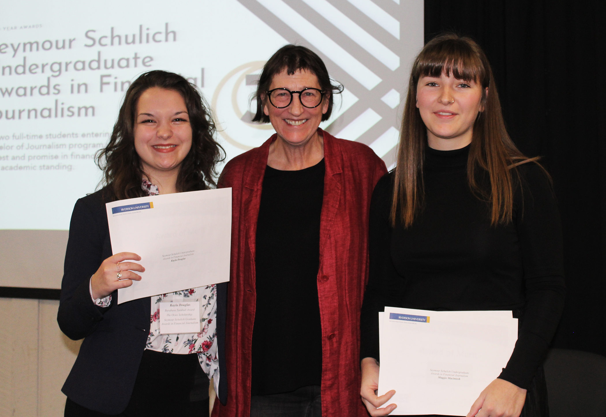 Seymour Schulich Undergraduate Awards in Financial Journalism recipients Kayla Douglas (l) and Maggie Macintosh (r) with Awards Committee Chair Jagg Carr-Locke.