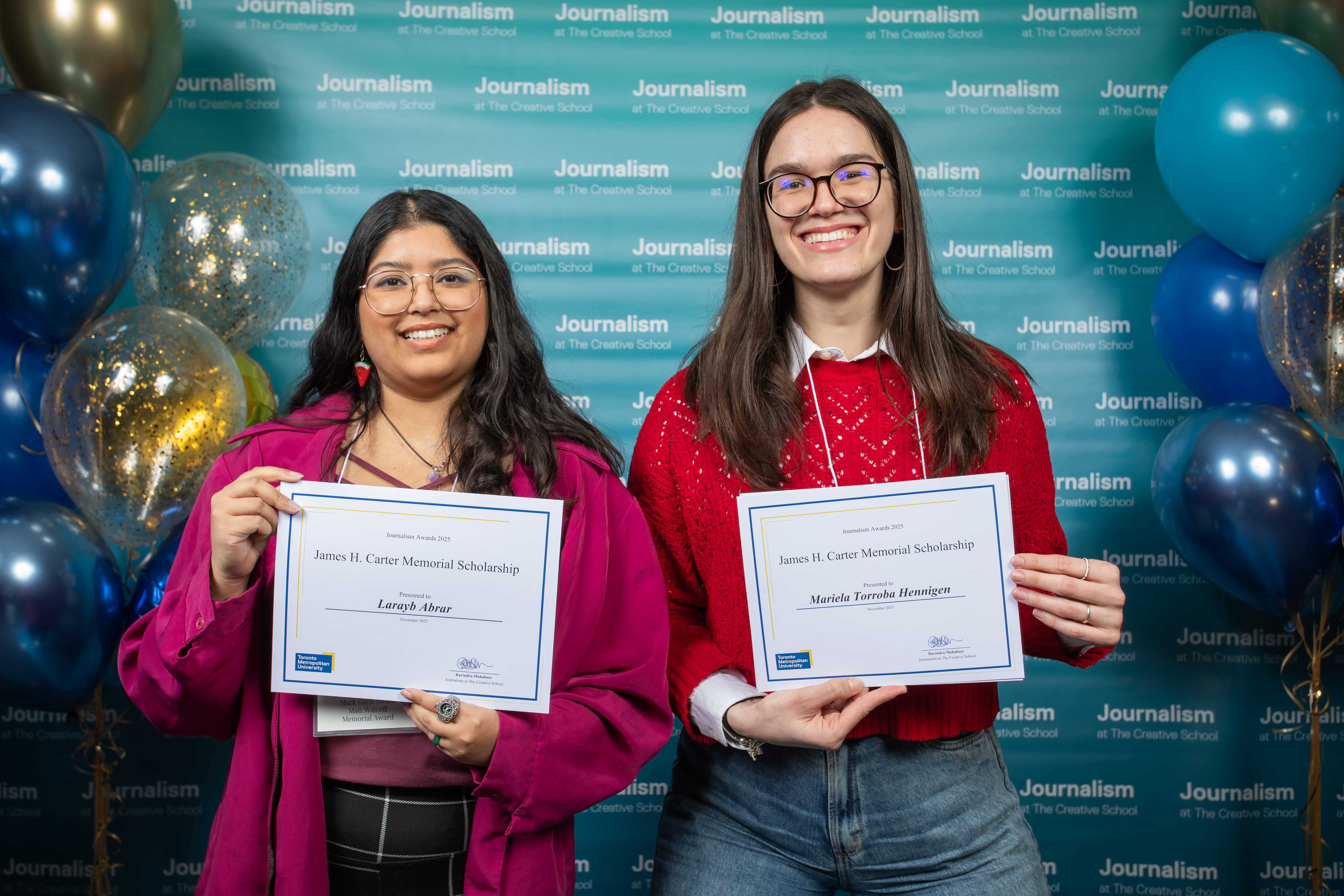 Photo of two people holding their certificates at Journalism School Award ceremony