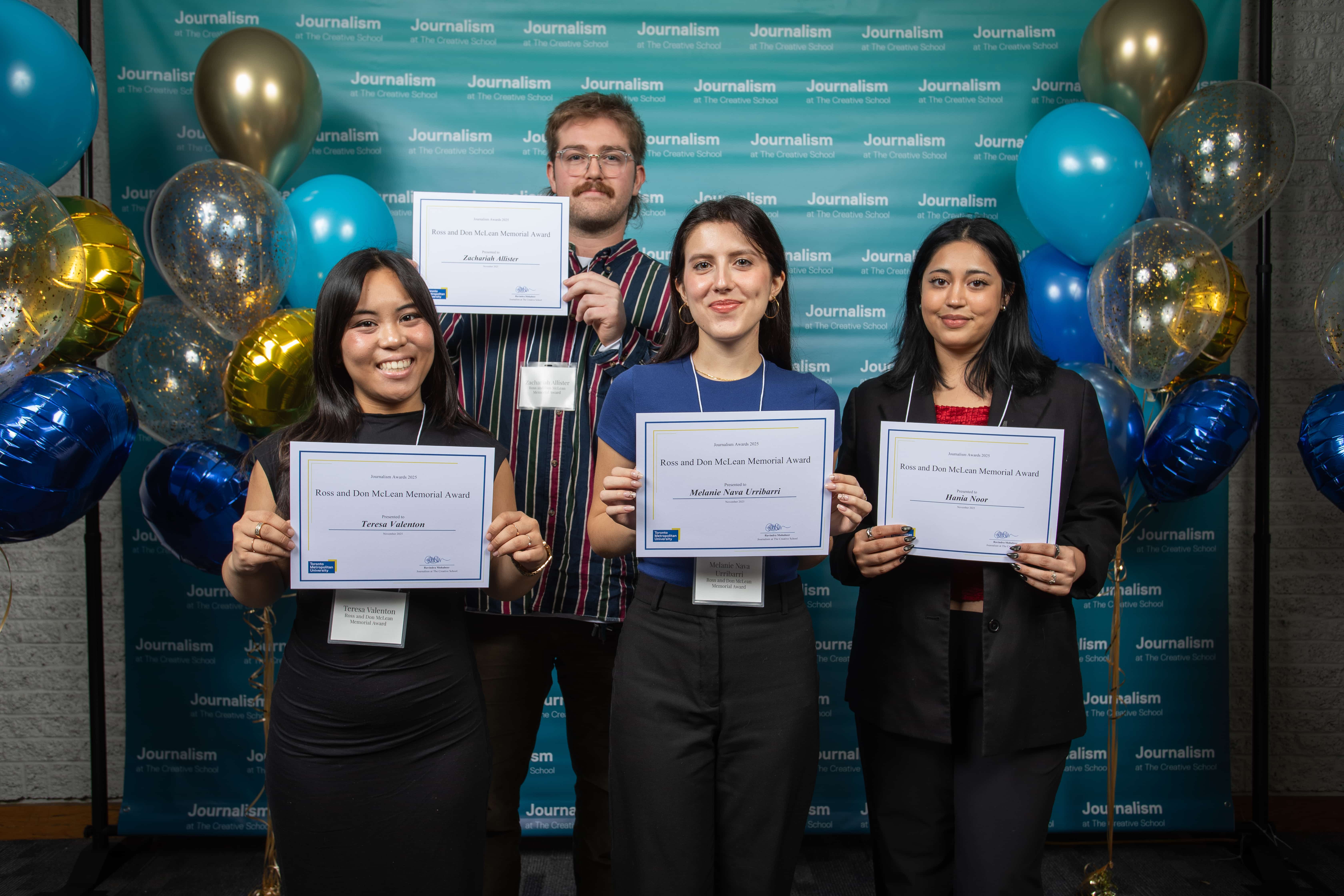 Four people holding certificates at the Journalism School Award Ceremony
