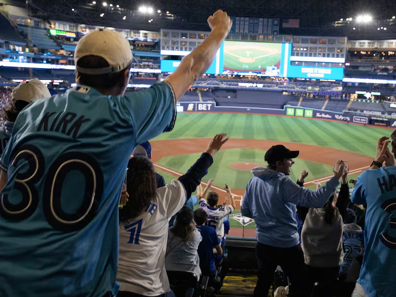 A photo of Rogers Centre, crowd cheers with everyone standing up.