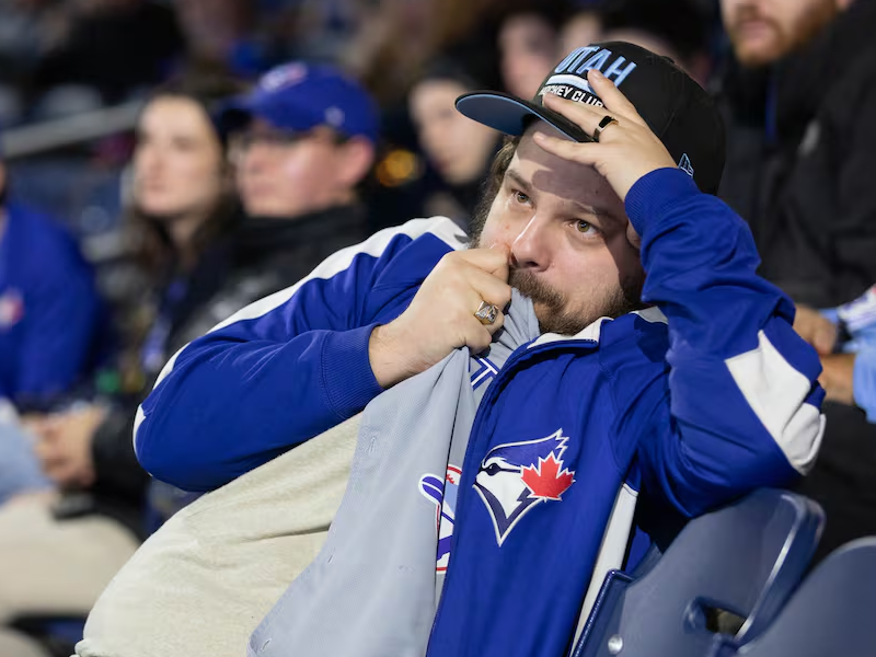 A person looks concerned away from the camera while clutching a shirt.