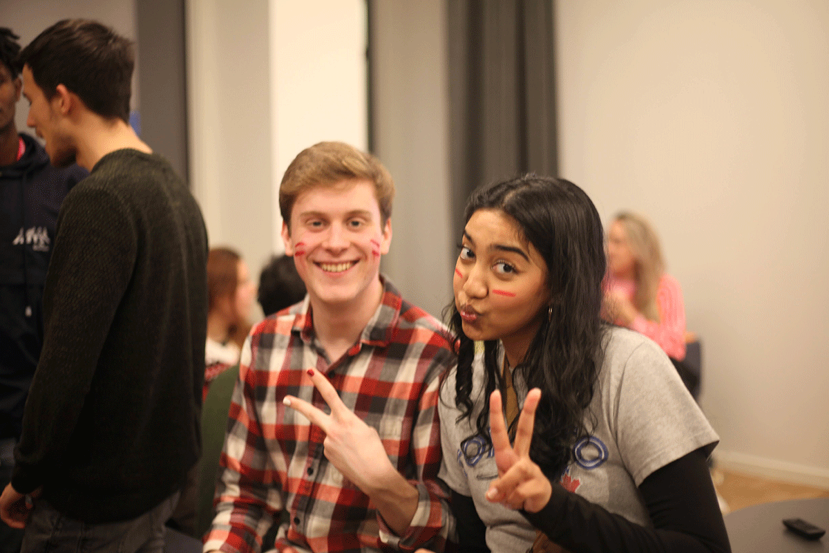 Monkman and Nashra Syed, another TMU j-school student, also on exchange in Denmark both with a hand in the air making the peace symbol.