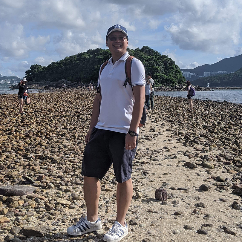 Photo of Eric Lam on a beach. 