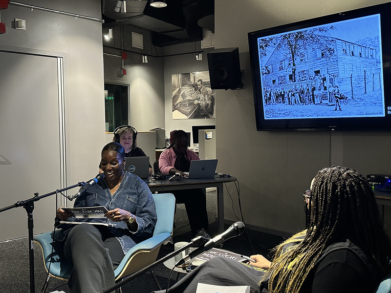 Journalism professor Shari Okeke chats with podcaster Nichole Hill during a podcast recording.
