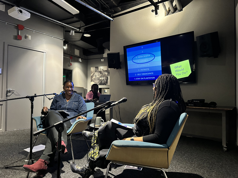Journalism professor Shari Okeke chats with podcaster Nichole Hill during a podcast recording.
