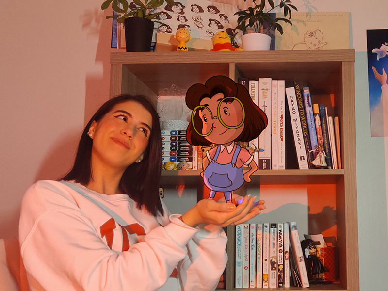 Dani Sadun is the creator and director of the animated film, Frida in the Sky. She is pictured with an animation of Frida. 