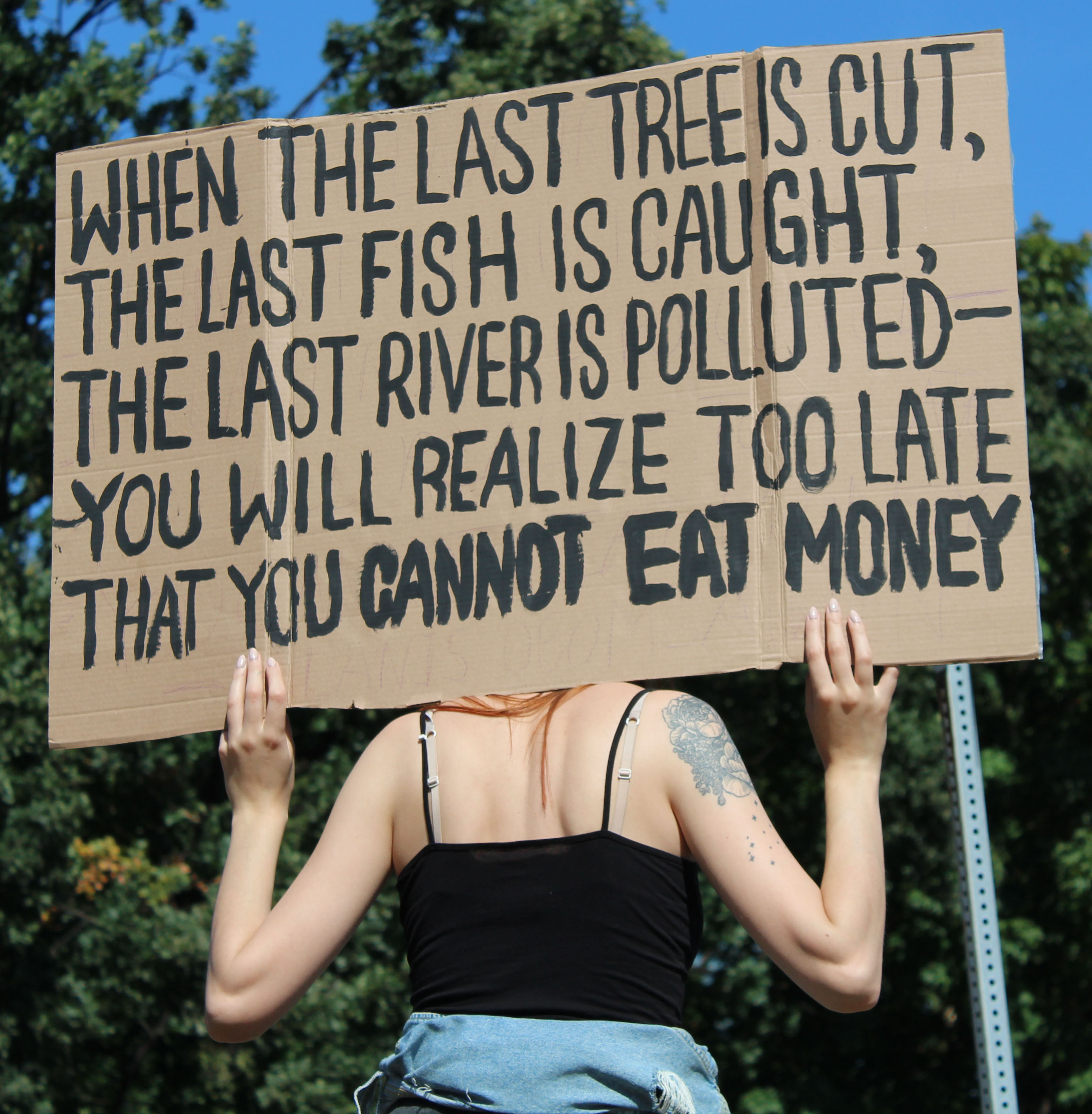 A woman holds her sign as she walks through Queen's Park during the climaten change protest in Toronto on Sept. 27, 2019.   Photo by  (Nikki Hashemian)