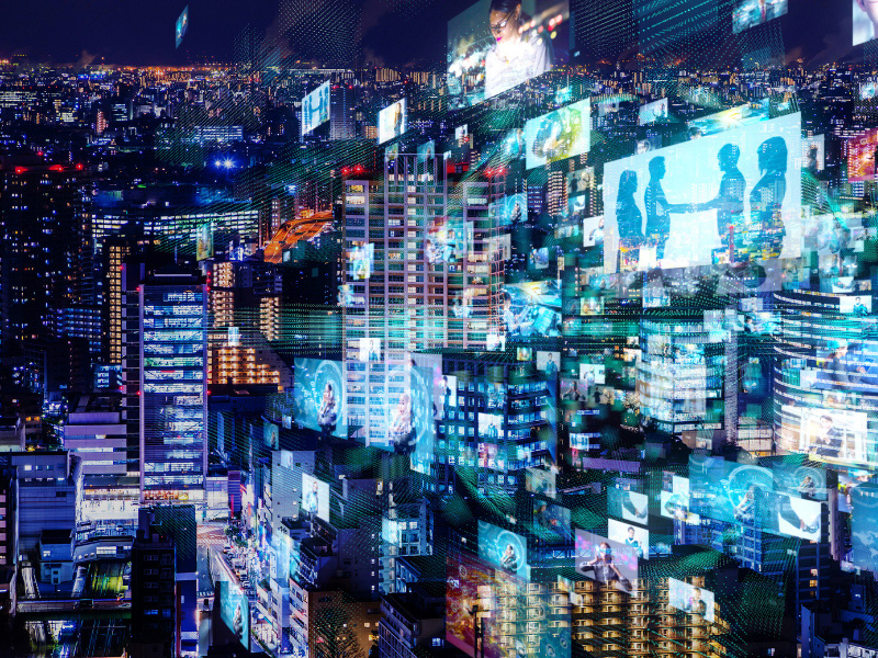 A collage of digital screens, bright lights and buildings are placed around each other.