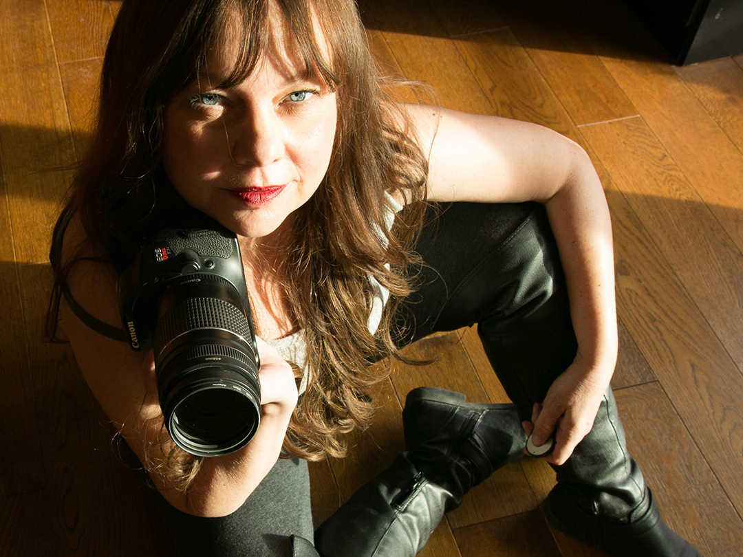 Photo of Karyn Pugliese with a camera