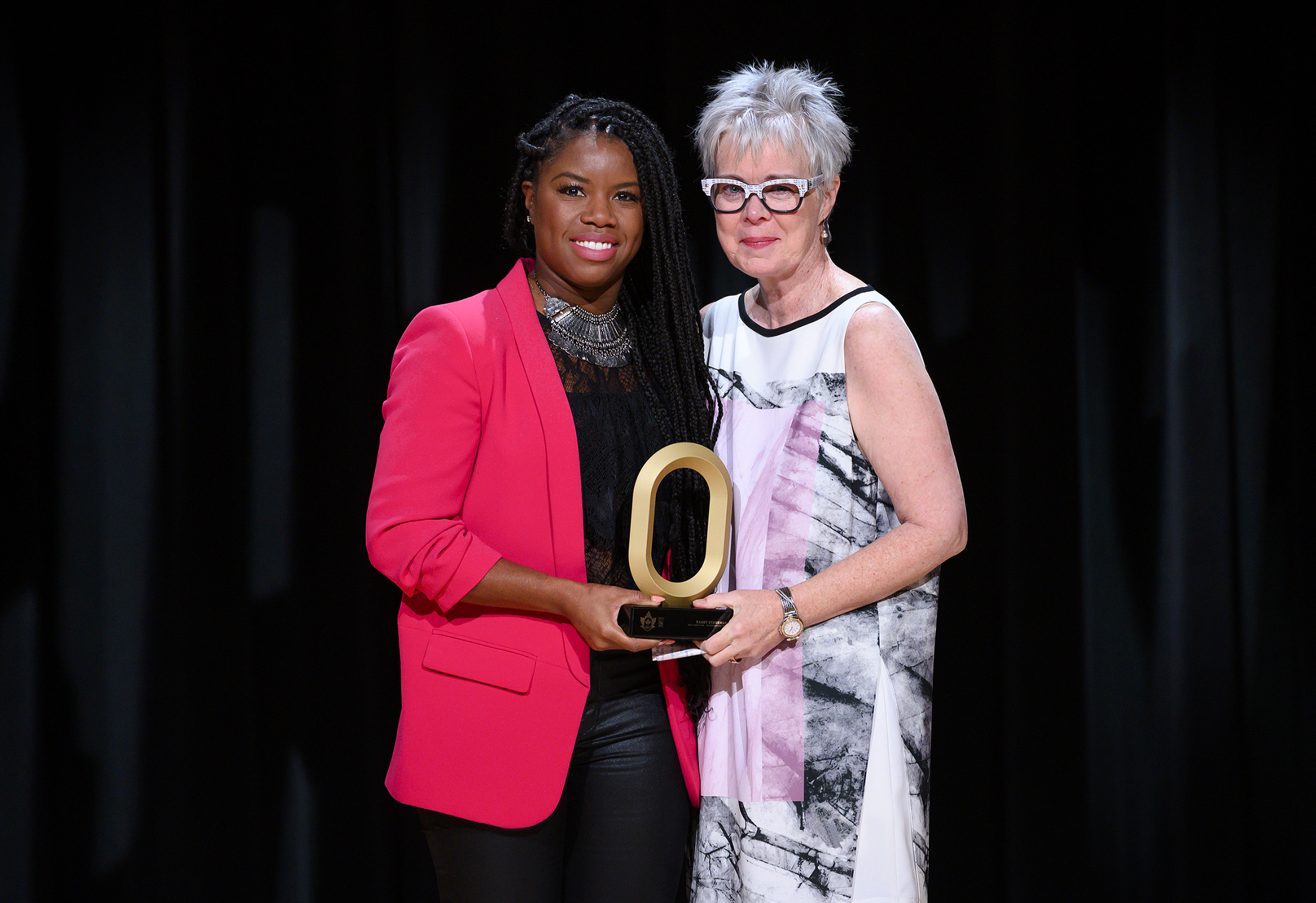 Mary Hynes, the wife of Randy Starkman, holds back tears as she accepts his induction into the Canadian Olympic Hall of Fame on his behalf.