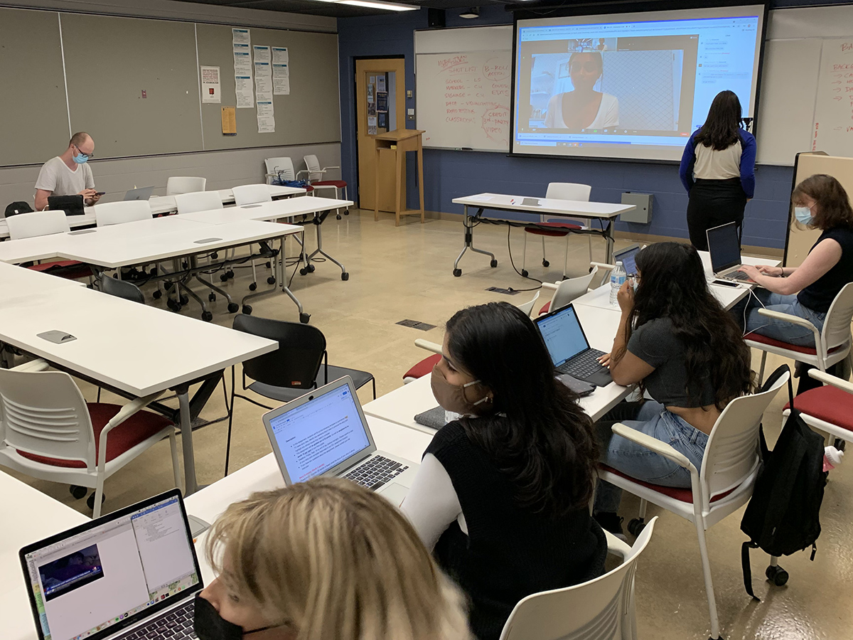 A hybrid class with students both in the classroom and participating online. 