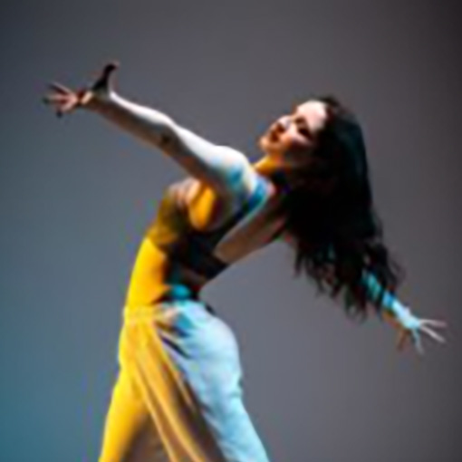 A woman in a yellow dress dancing