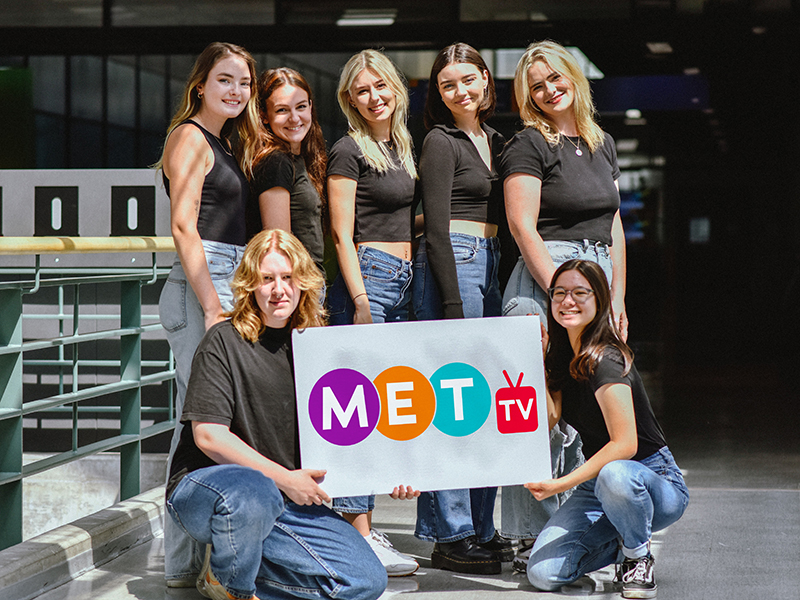 The MetTV relaunch team. Back row left to right: Maysee Mclean (VP Outreach), Ainsley Cherry (VP Production), Jessica Bernt (VP Finance), Kiera Meinhert (VP Marketing), Sabrina Pontello (President). Front row left to right: Mary Rodgers (VP of Tech), and Ailey Yamamoto (VP Operations). Not Pictured: Angie Massiah (VP Programming)