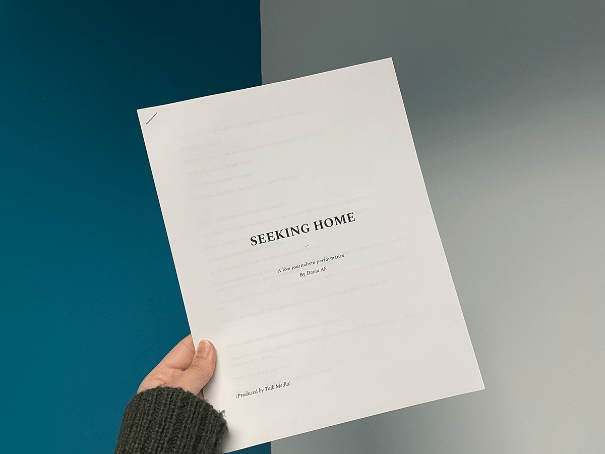 A hand holding a copy of a script title Seeking Home