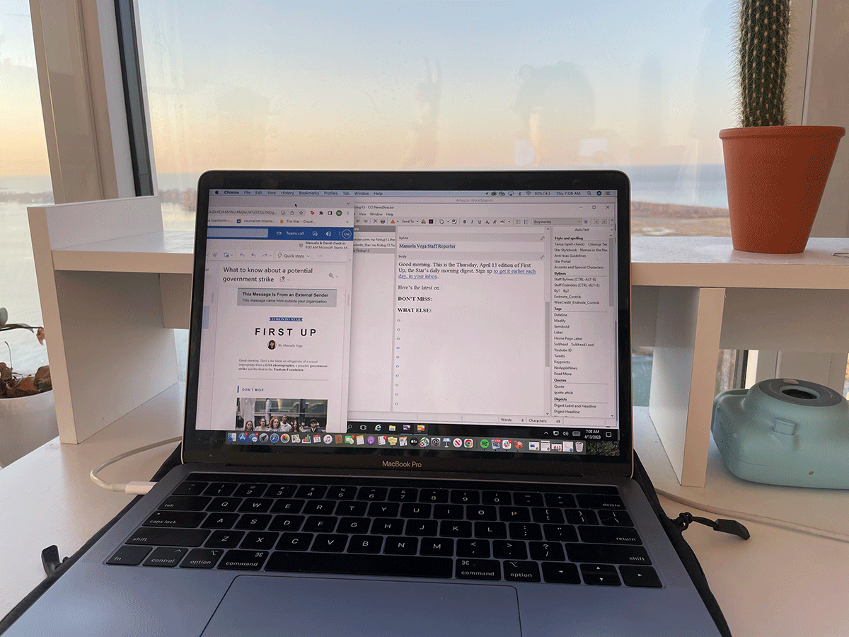 A laptop sitting on a desk with the morning sky in the background.
