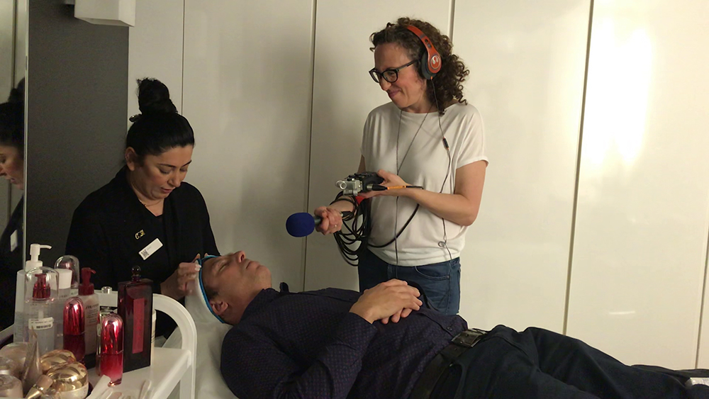 Podcaster interviewing a man. 