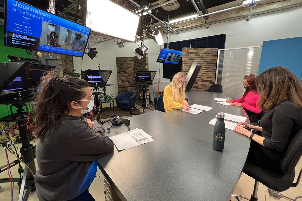 Students and a member of the tech staff working in the studio. 