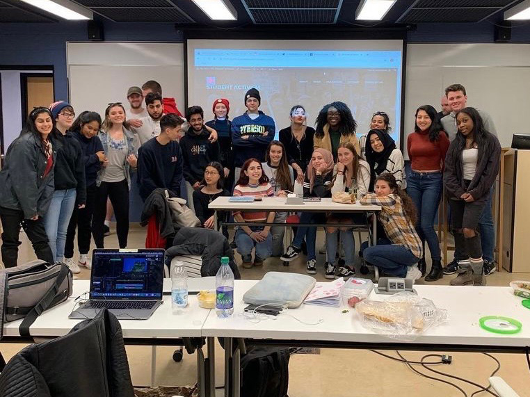 A group photo of a class in a classroom.