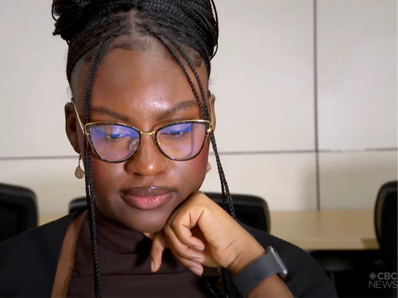 A close up of Tomi Joseph-Raji with glasses as she looks down at a laptop.