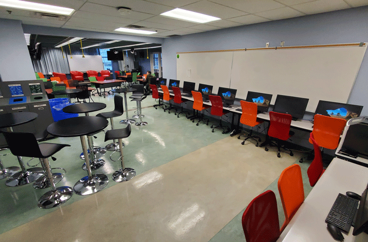 A number of desks and chairs set up with computers in the Venn Reporting Centre.