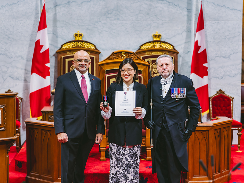 Anita Li receiving the King Charles III Coronation Medal. 
