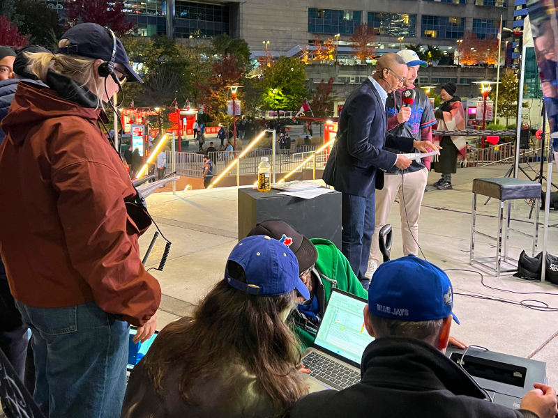 Outside the Rogers Centre a camera crew is doing a live hit about a game.