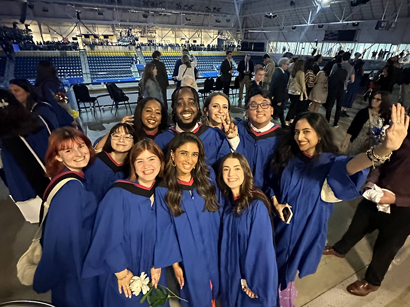 TMU J-school graduates pose for a picture after their ceremony at the Mattamy Athletic Centre