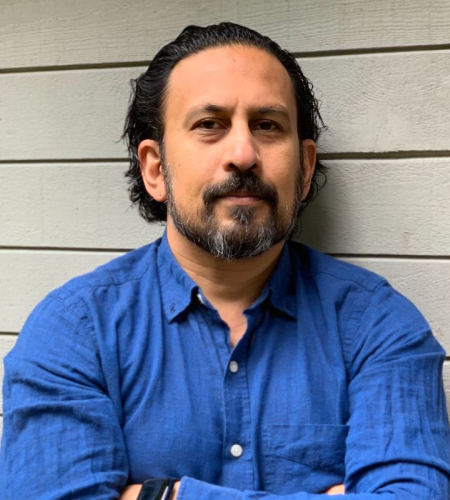Headshot of Journalism chair Ravindra Mohabeer wearing a business shirt