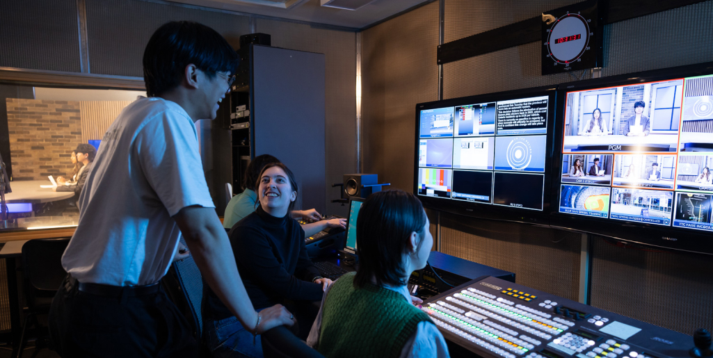 three students working on a Journalism production studio