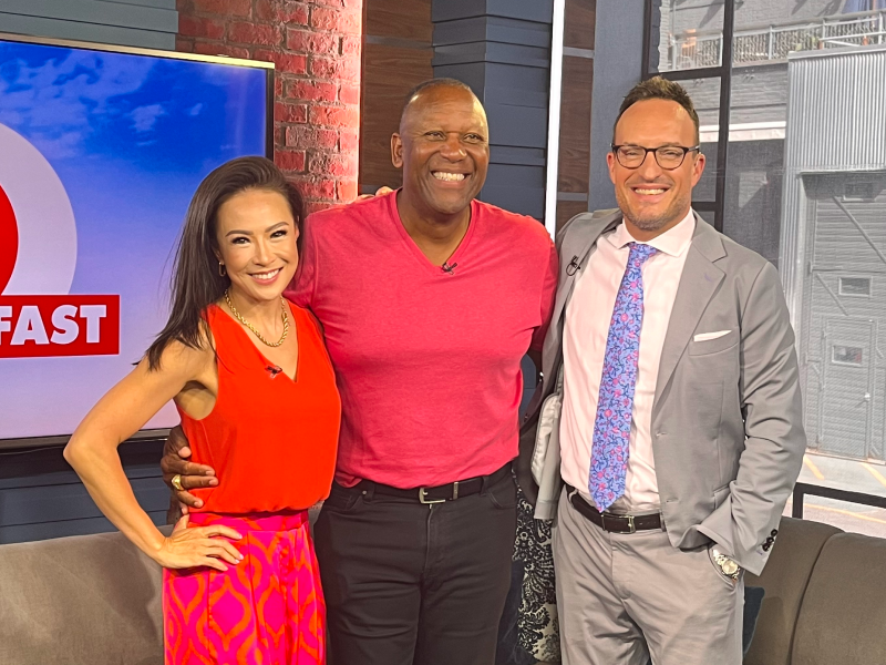 Three people stand in a row while looking at the camera