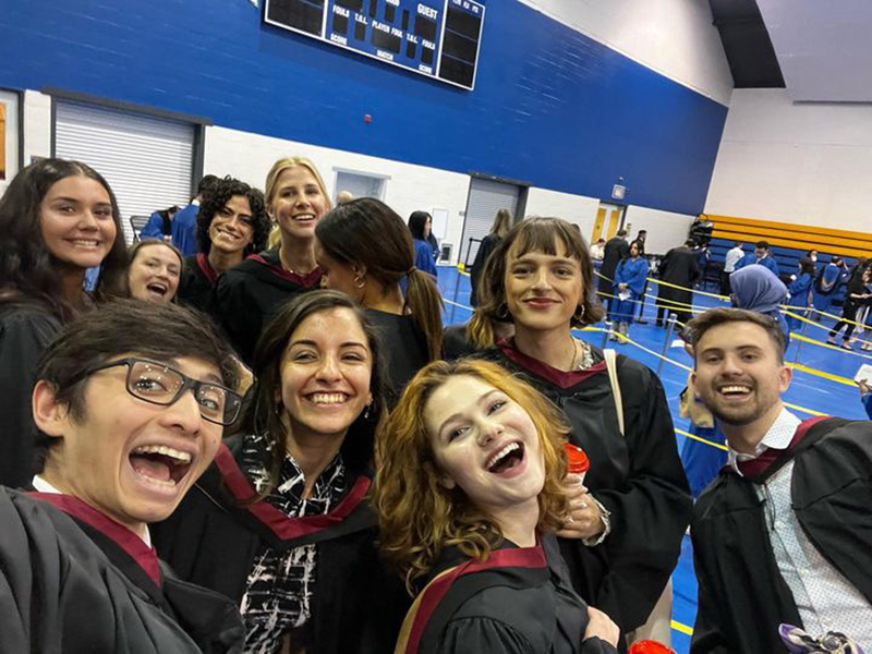 A group of 2023 School of Journalism graduates take a photo together at convocation.