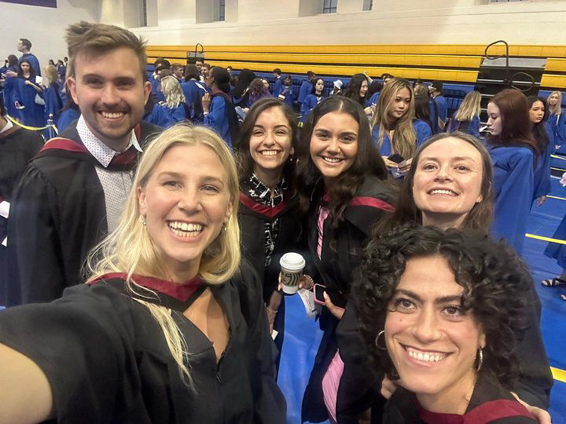 A group of 2023 School of Journalism graduates take a photo together at convocation.