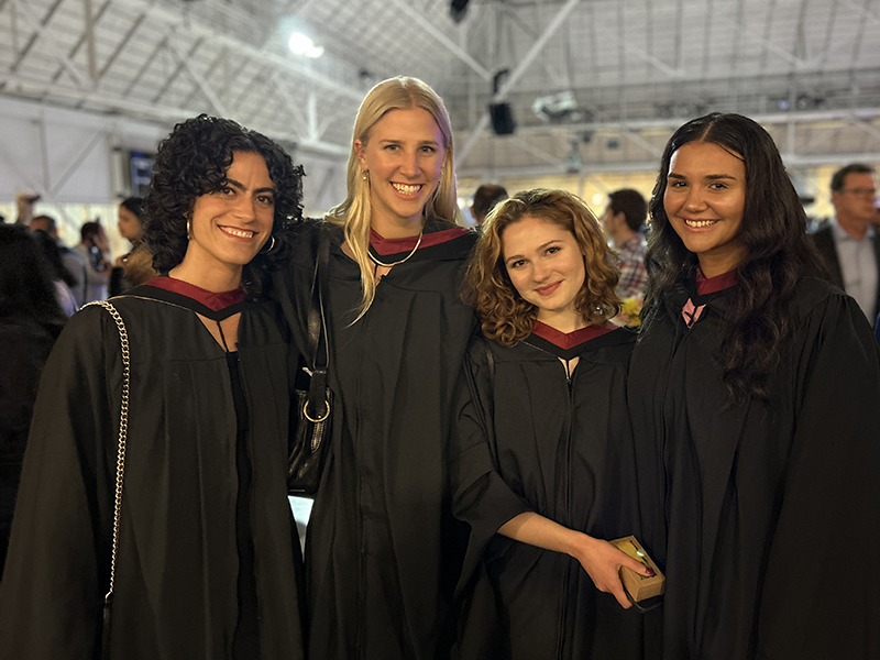 Four School of Journalism 2023 grads at convocation stand together.