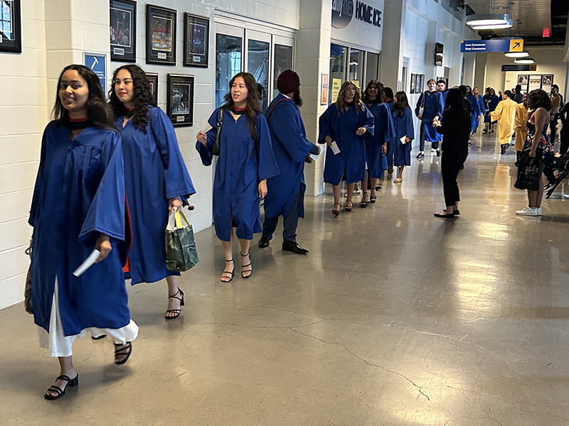 School of Journalism 2023 graduates walk into the convocation ceremony.
